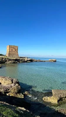 a view of the water with a lighthouse in the background at Morgana Holiday in Carini