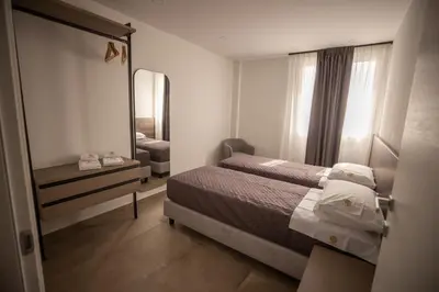 a small bedroom with a bed and a mirror at Richgood Luxury homes - Villa Zefira sole in Altavilla Milicia