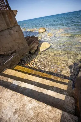 a stairway leading into the water near the ocean at Richgood Luxury homes - Villa Zefira sole in Altavilla Milicia