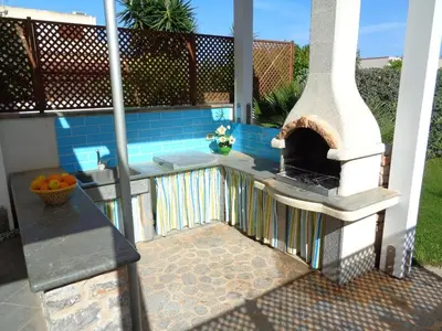 a outdoor kitchen with an outdoor oven on a patio at Villa La Chiocciola in San Vito lo Capo