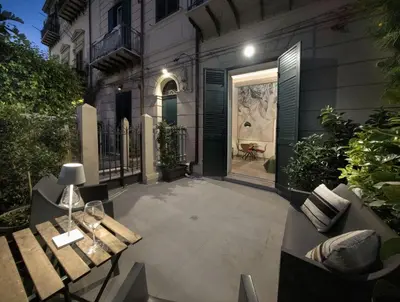a desk with a laptop and a tv on a wall at Bonsai Loft in Palermo