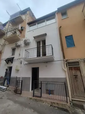 a building with two balconies on the side of it at Mumin in Carini