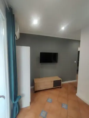 a living room with a flat screen tv on a wall at Mumin in Carini