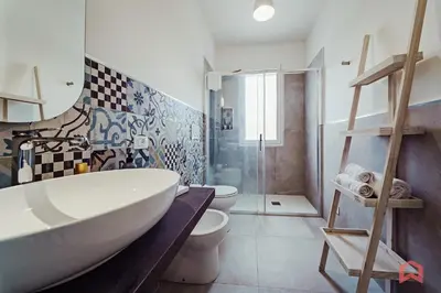 a bathroom with a tub and a toilet and a shower at Deliziosa Villa con Piscina e Jacuzzi a Scopello in Castellammare del Golfo
