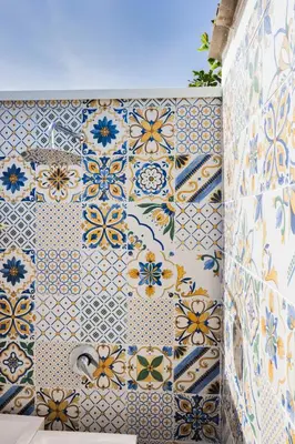 a tiled wall with blue and yellow flowers on it at Richgood Luxury homes - Villa Zefira mare in Altavilla Milicia