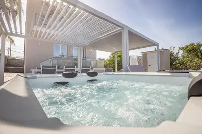 a swimming pool in the middle of a house at Richgood Luxury homes - Villa Zefira mare in Altavilla Milicia