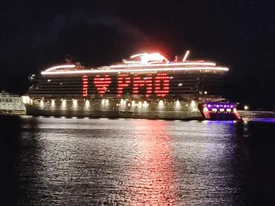 a cruise ship sitting on the water at night at FALSTAFF 2 Apartment in Palermo