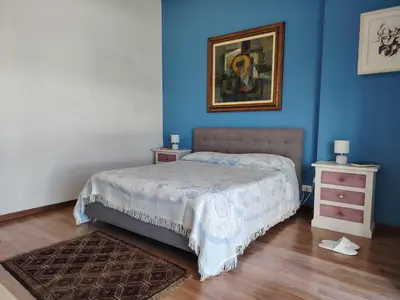a bedroom with a bed and a painting on the wall at FALSTAFF 2 Apartment in Palermo