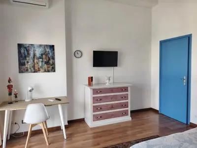 a bedroom with a desk and a tv and a dresser at FALSTAFF 2 Apartment in Palermo
