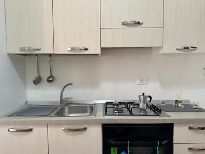a kitchen with a sink and a stove at Casa Costa in Capaci