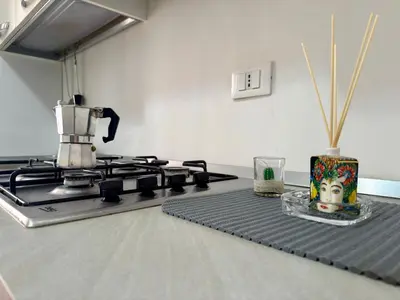 a kitchen with a stove with a coffee pot on it at Casa Costa in Capaci