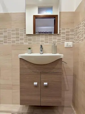 a bathroom with a sink and a mirror at Casa Costa in Capaci