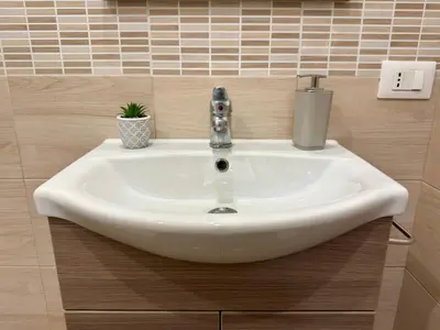 a sink with a faucet in a bathroom at Casa Costa in Capaci