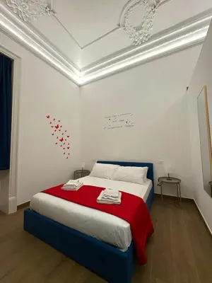 a white ceiling with a clock on the ceiling at Gea Apartment in Palermo