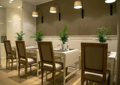 a dining room with a table and chairs with plants at Suite 136 in Palermo