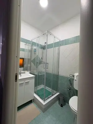 a bathroom with a shower with a sink and a toilet at Le mura di San Vito in Palermo