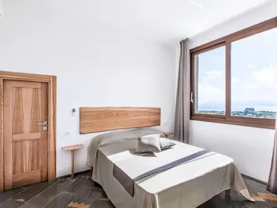 a bedroom with a bed and a large window at Villa Cleope by Interhome in Castellammare del Golfo