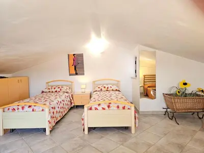a bedroom with two beds and a mirror at Holiday Home Villa mit Wasserblick by Interhome in Cefalù