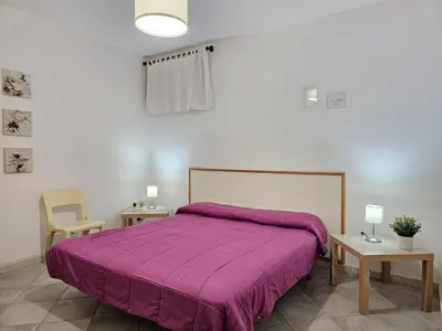 a bedroom with a bed with a purple blanket at Holiday Home Villa mit Wasserblick by Interhome in Cefalù