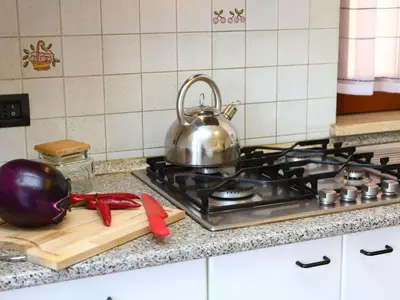 a silver tea pot sitting on top of a stove at Holiday Home Helle mediterrane Villa mit Veranda und Garten by Interhome in Cefalù