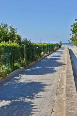 an empty road with a fence on the side at Holiday Home Helle mediterrane Villa mit Veranda und Garten by Interhome in Cefalù