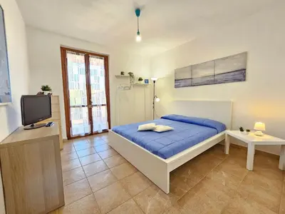 a bedroom with a bed and a tv in it at Holiday Home Helle mediterrane Villa mit Veranda und Garten by Interhome in Cefalù