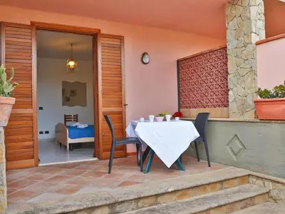 a table and chairs on the patio of a house at Holiday Home Helle mediterrane Villa mit Veranda und Garten by Interhome in Cefalù
