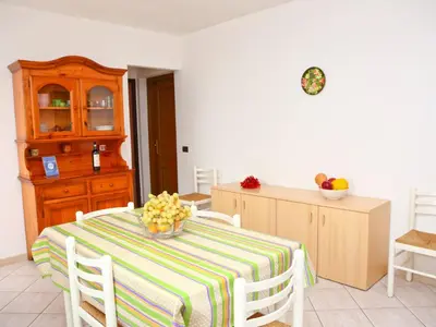 a kitchen with a table with a bowl of flowers on it at Holiday Home Helle mediterrane Villa mit Veranda und Garten by Interhome in Cefalù