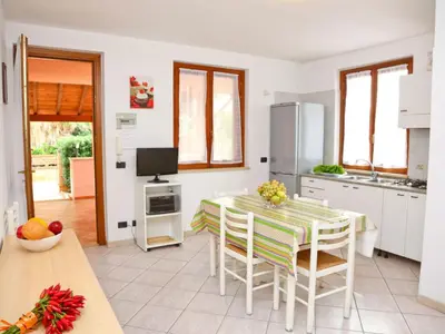 a kitchen and dining room with a table and chairs at Holiday Home Helle mediterrane Villa mit Veranda und Garten by Interhome in Cefalù