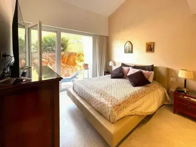 a bedroom with a bed and a large window at Sustainable Villa With Infinity Pool in Castellammare del Golfo