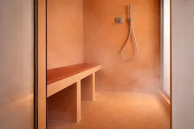 a bathroom with a shower with a wooden bench at Dimora Monteleone in Palermo