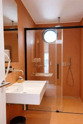a bathroom with a sink and a glass shower at Dimora Monteleone in Palermo