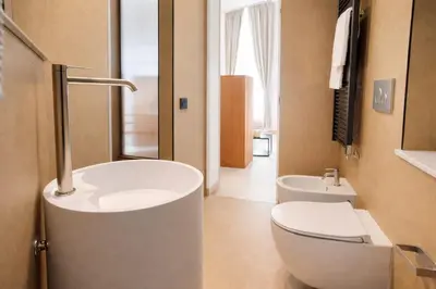 a bathroom with a toilet and a sink at Dimora Monteleone in Palermo