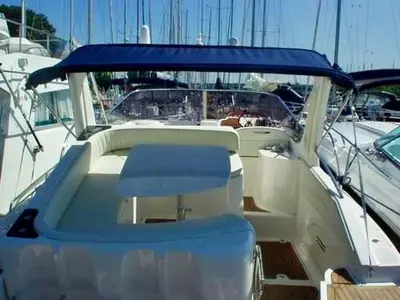 a white boat with a blue seat in a dock at Palermo Boat Experience in Isola delle Femmine
