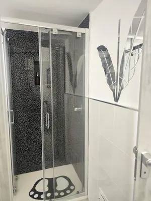 a shower with a glass door in a bathroom at Magic House in Palermo