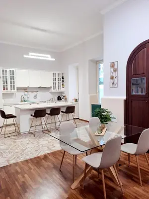 a kitchen with a glass table and chairs at Clara Bedda in Palermo