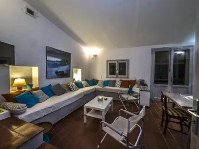 a living room with a couch and a table at Chalet Le Palmette in Contrada Sauci Grande