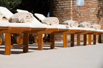 a row of benches with towels on top of them at Exclusive Villa Eden in Castellammare del Golfo