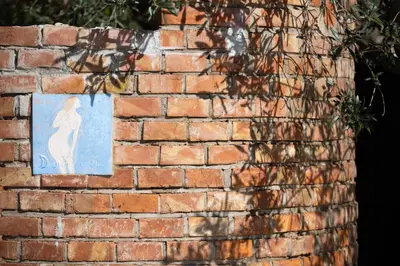 a brick wall with a picture of a woman on it at Exclusive Villa Eden in Castellammare del Golfo