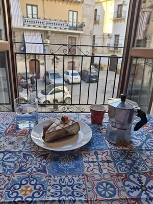 a plate of food on a table with a view of a street at Compa House - Palermo Center in Palermo