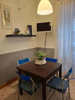 a dining room with a table and blue chairs at Compa House - Palermo Center in Palermo