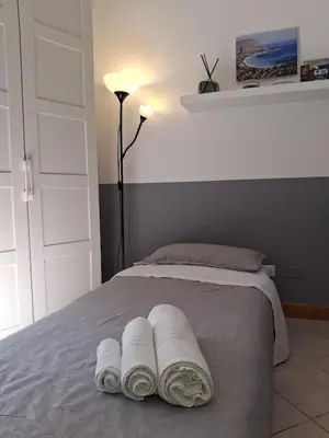 a bedroom with a bed with towels on it at Compa House - Palermo Center in Palermo