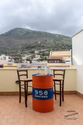 a table and chairs with a view of a mountain at Sapori di Sicilia Apartments in Palermo
