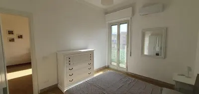 a white room with a dresser and a window at Magia del Sud in Palermo