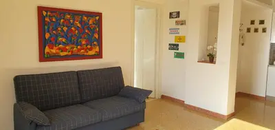 a couch in a room with a painting on the wall at Magia del Sud in Palermo