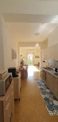 a large kitchen with a table and a dining room at Magia del Sud in Palermo