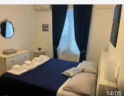 a bedroom with a blue bed with towels on it at Chiaro di luna holiday in Palermo