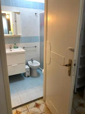 a bathroom with a toilet and a sink at Chiaro di luna holiday in Palermo