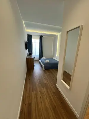 a bedroom with a bed and a large mirror at Maison Butera in Palermo