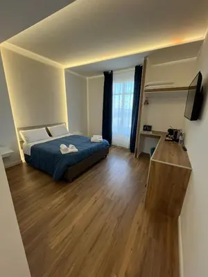a bedroom with a bed and a wooden floor at Maison Butera in Palermo